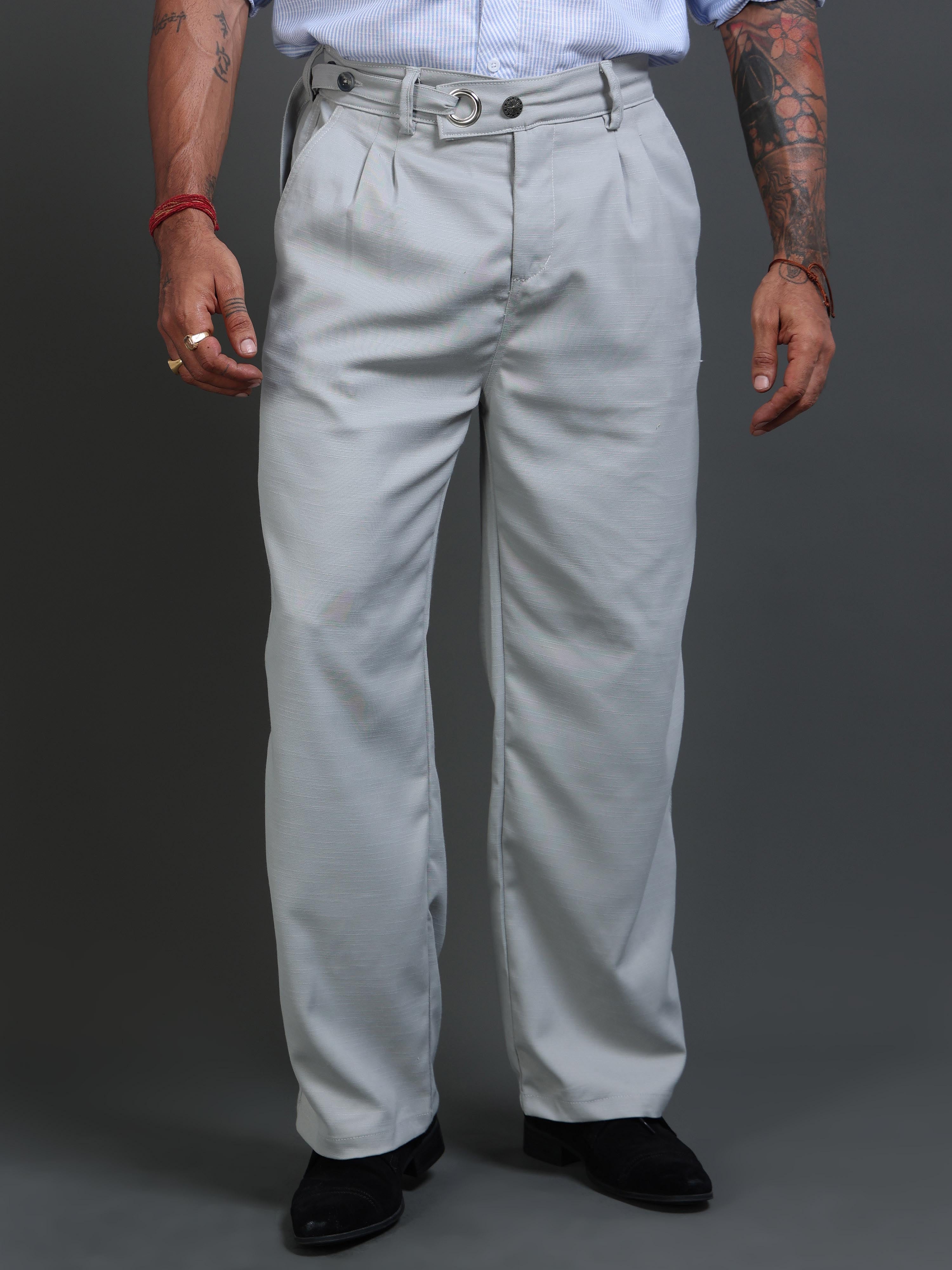 Man wearing pleated formal trousers styled for office and business casual settings.