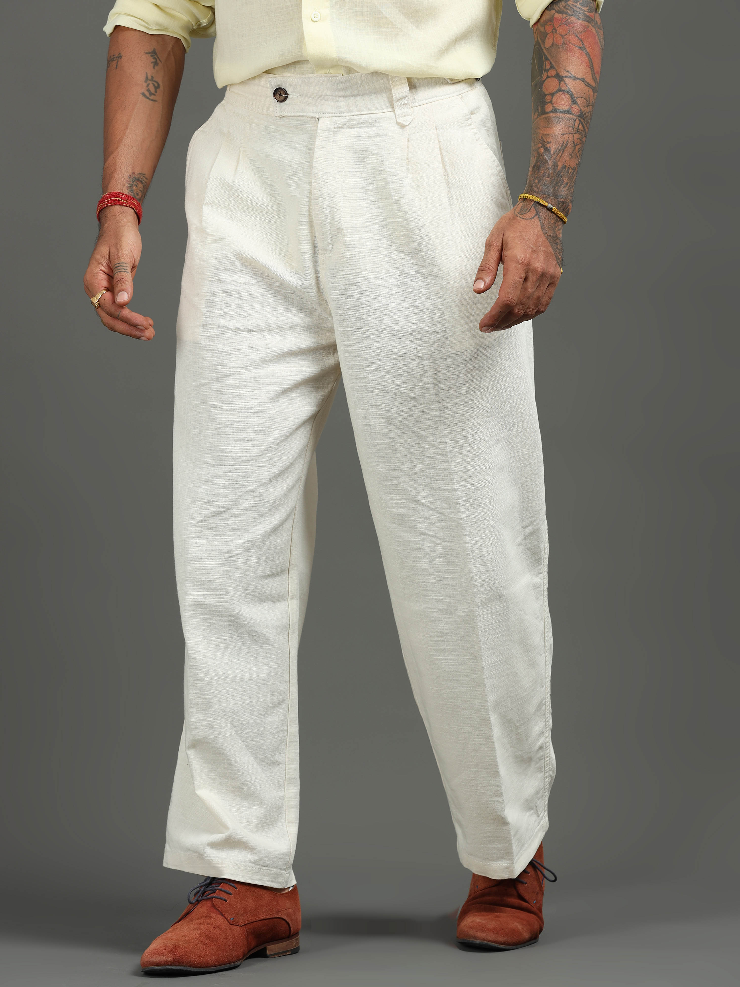 Man wearing pleated formal trousers with a crisp shirt for clean office style and comfort.