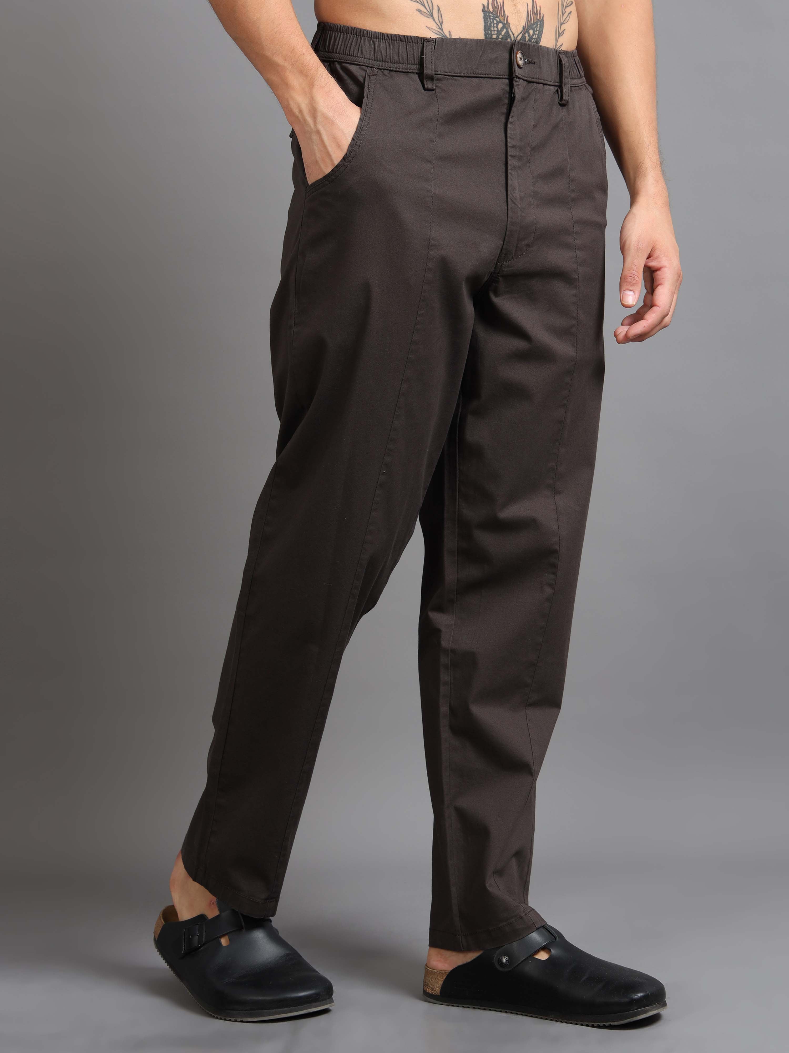 Man wearing zip relaxed trousers styled with a clean shirt for modern smart casual comfort.