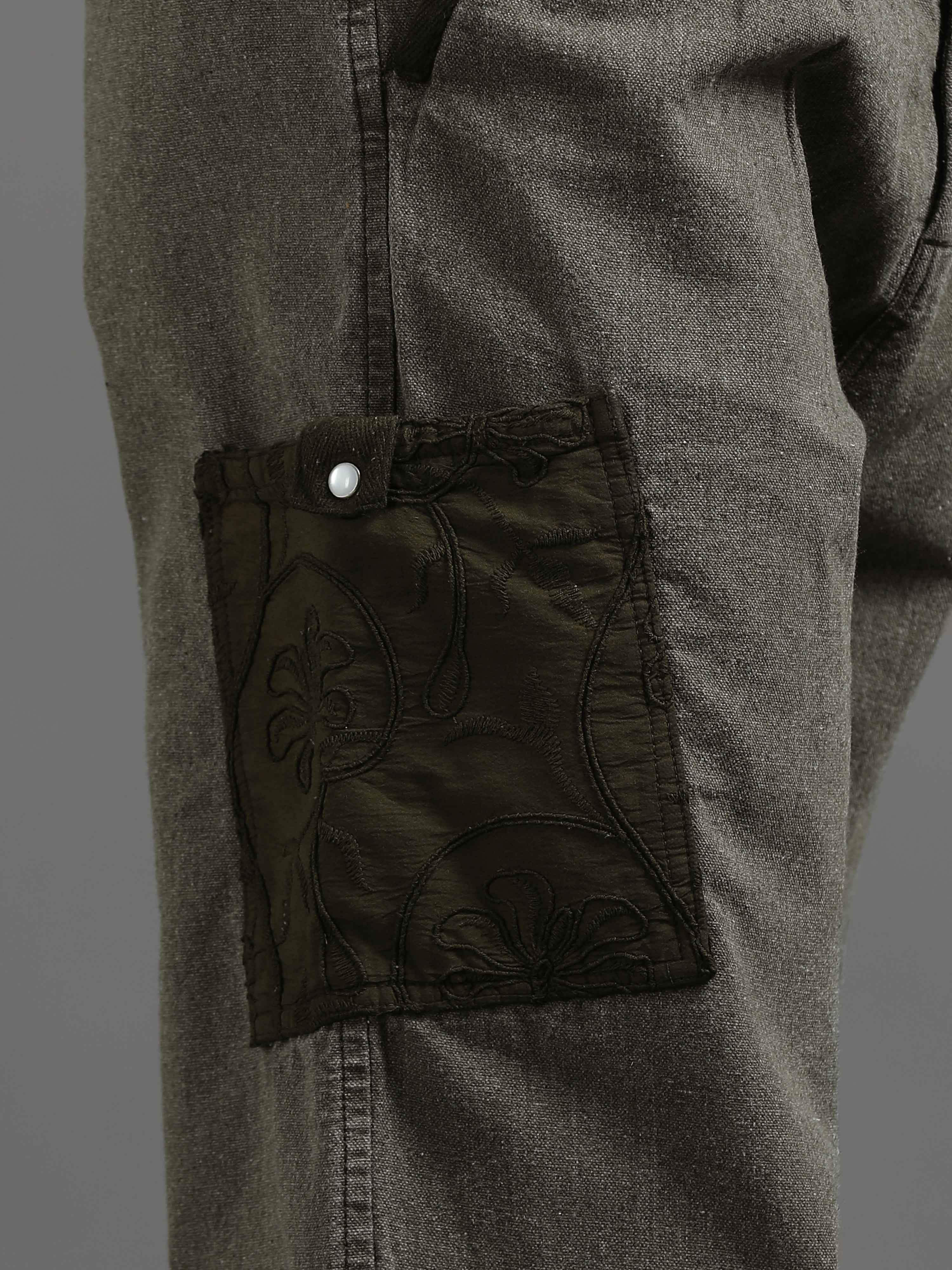 Man checking cargo pants online for fit, pocket placement, and color.