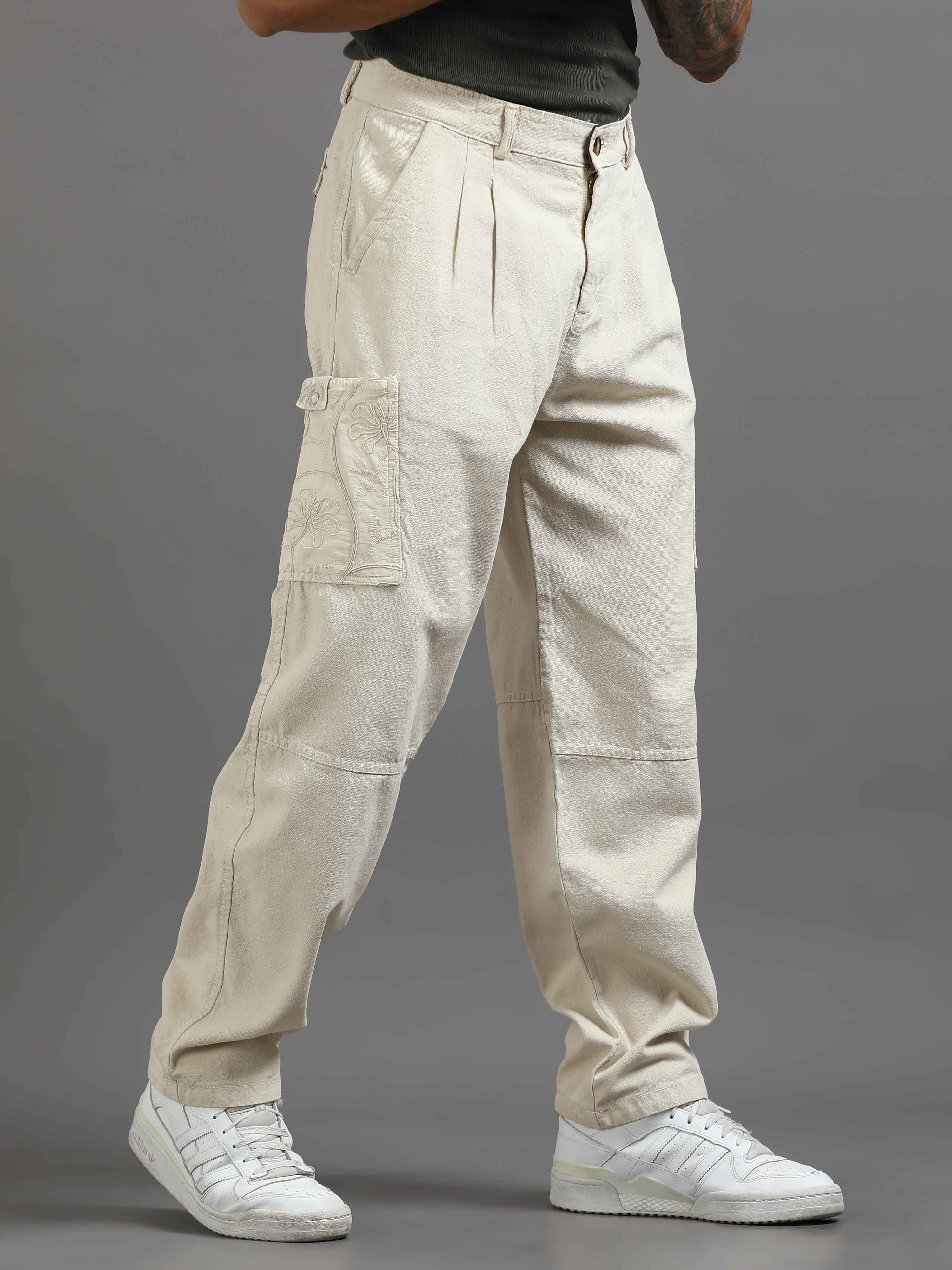 Man wearing pleated cargo pants styled with a shirt for modern smart casual utility fashion.